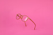© New Africa - Glasses with corrective lenses on bright pink background