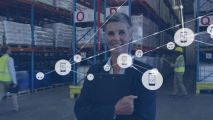 Poster - Animation of connected icons over short hair caucasian woman standing with notepad in warehouse