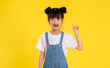 image  of  asian little girl posing on a yellow background