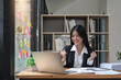 © Natee Meepian - Happy excited successful businesswoman triumphing in office