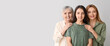 © Pixel-Shot - Portrait of beautiful mature woman, her daughter and mother on light background with space for text