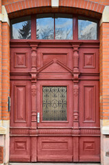 Sticker - View of brick building with red wooden door