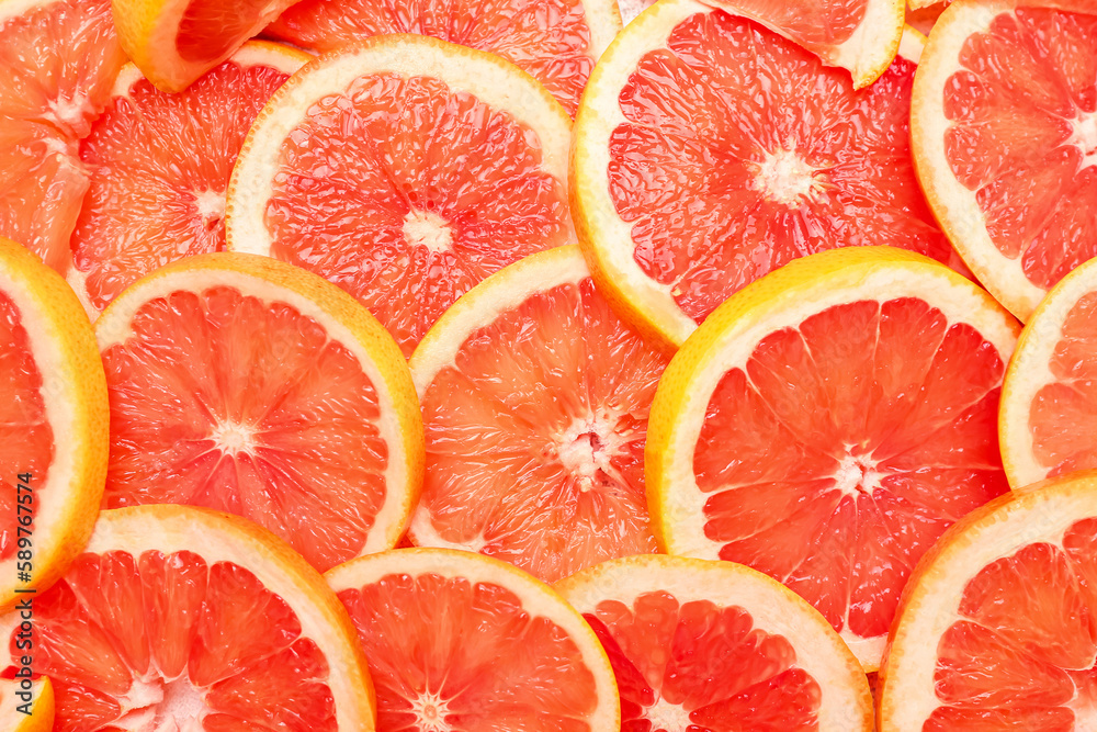 Slices of juicy ripe grapefruit as background, closeup
