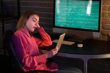 Poster - Female programmer working with tablet computer in office at night