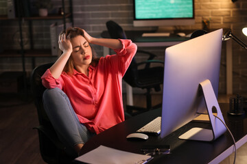 Stressed female programmer working in office at night