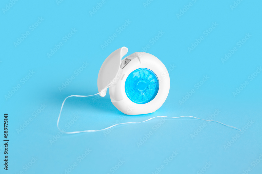 Case with dental floss on blue background