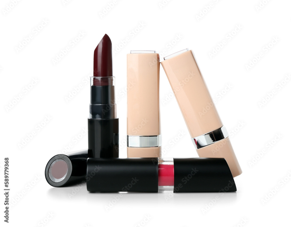 Different lipsticks on white background