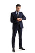 © Pixel-Shot - Handsome businessman looking at smartwatch on white background