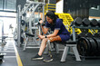 © Wosunan - Young female with one prosthetic leg warms up by lifting light weights. Concept of living a woman's life with a prosthetic limb.
