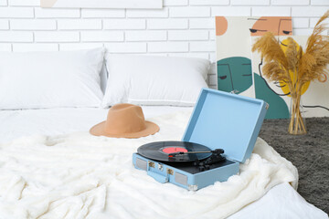 Wall Mural - Record player with vinyl disk on bed in room