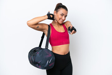 Wall Mural - Young sport woman with sport bag isolated on white background making phone gesture and pointing front