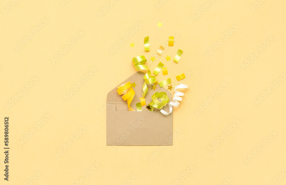 Composition with envelope and confetti on yellow background