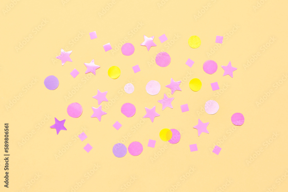 Composition with confetti and stars on yellow background