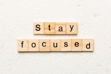 stay focused word written on wood block. stay focused text on table, concept