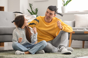 Poster - Portrait of father and his little daughter with paper mustache at home