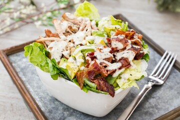 Sticker - Bowl of BLT salad with lettuce, meat, bacon and avocados