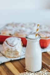 Sticker - Vertical of the fresh milkshake and cinnamon rolls on the put on the wooden table