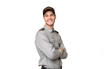 Wall Mural - Young security man over isolated background with arms crossed and looking forward