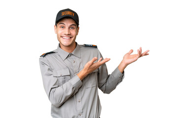 Wall Mural - Young security man over isolated background extending hands to the side for inviting to come