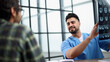 © Katsiaryna - Cheerful male patient and doctor shaking hands.