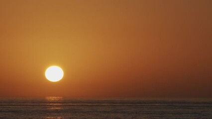 Wall Mural - beautiful evening sunset with big sun in the atlantic ocean at portugal coast.