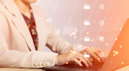 Poster - Businesswoman tying to connecting with cloud folder file and data virtual screen orange background. Technology concept.