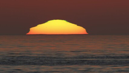 Wall Mural - beautiful evening sunset with big sun in the atlantic ocean at portugal coast.