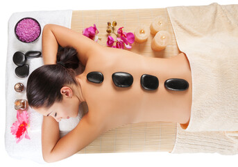 Wall Mural - Beautiful young woman receiving hot stone massage at salon spa