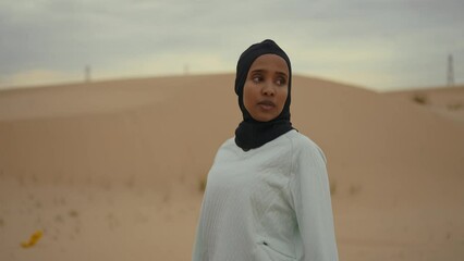 Wall Mural - Beautiful female runner wearing sport abaya running in the desert in dubai, united arab emirates. Concept about sport, and muslim culture