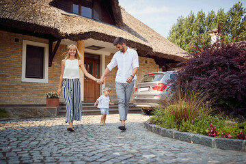 Wall Mural - Couple with child together walking