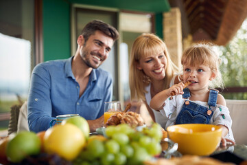 Wall Mural - Cute girl eating backed stick for breakfast