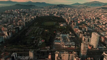 Poster - Aerial view of a city in the hills at calm sunset