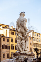 Neptune Statue in Florence, Italy with classic Italian architecture in the back.