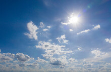 Blue Sky Background With The Sun And Beautiful White Cloud Nature Background, Idea For Website Or Wallpaper Background.