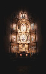 vertical shot of the bright lights on the saints in the church altar