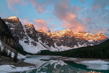 Poster - Beautiful view of a snowy mountain against a cloudy sky with a lake in the foreground