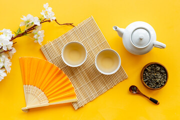 Wall Mural - Asian tea ceremony with fan and cherry blossom branch