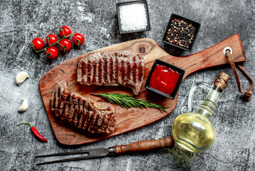 Poster - grilled beef steak on stone background