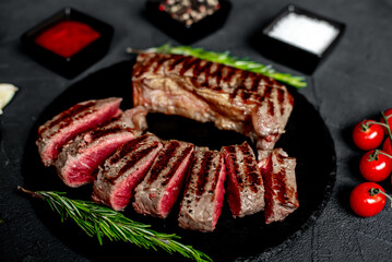 Poster - grilled beef steak on stone background