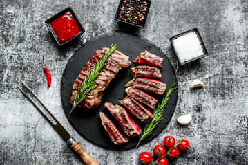 Poster - grilled beef steak on stone background