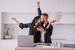 © Iona - Excited caucasian couple after calculate their year earnings, celebrating successful business at new home using calculator, laptop. Woman kisses husband holds papers. Financial freedom. Triumph.