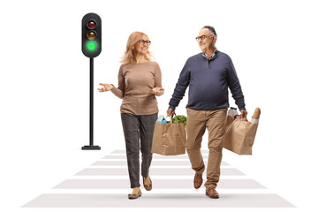 Canvas Print - Man carrying grocery bags and having a conversation with a woman at a pedestrian crossing