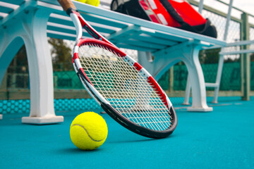 Wall Mural - Tennis racket and ball on the blue-coated court