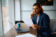 © Drazen - Male entrepreneur working on business reports in office.