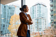 © Drazen - Satisfied businesswoman looking through window in her office.