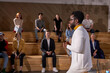 © Roman - male african-american speaker giving presentation in lecture hall, audience. Young participants students in the background. Conference event, training. Education, diversity, inclusive concept.