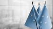 Small flags of the Federated States Micronesia on an abstract blurry background