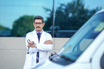 Wall Mural - Confident indian male doctor standing at hospital