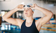 © Azeemud/peopleimages.com - Professional swimming, woman with goggles at pool for training and exercise, wellness and winner mindset. Water sports, workout and champion USA swimmer at swim competition with pride and confidence.