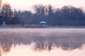 Poster - Beautiful scenery of wooden pier by misty lake in morning light. Otomin Lake, Kashubia, Poland